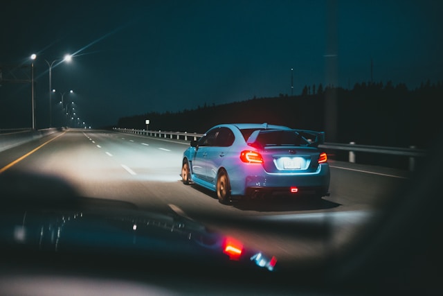 Hands holding car keys over a blurred keyboard and laptop, symbolizing smart decision-making with online auto insurance tools