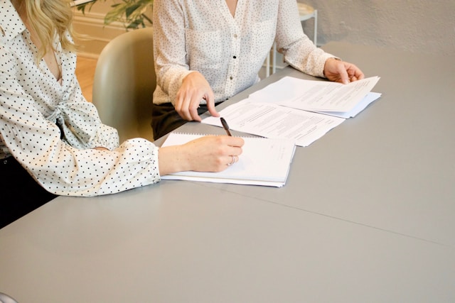 A balance scale with 'client care' on one side and 'personal protection' on the other, illustrating the harmony achieved with professional liability insurance for social workers.
