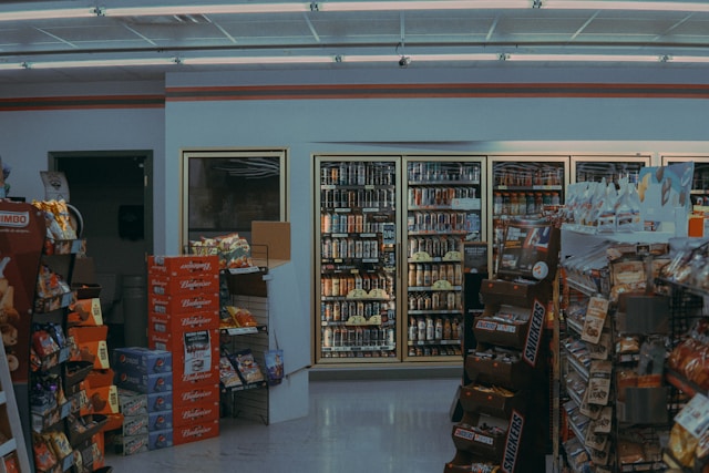 A convenience store owner reviewing insurance documents, symbolizing smart business protection
