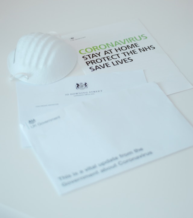 A person confidently holding a letter of experience insurance document, showing it to a smiling insurance agent, symbolizing successful premium reduction.